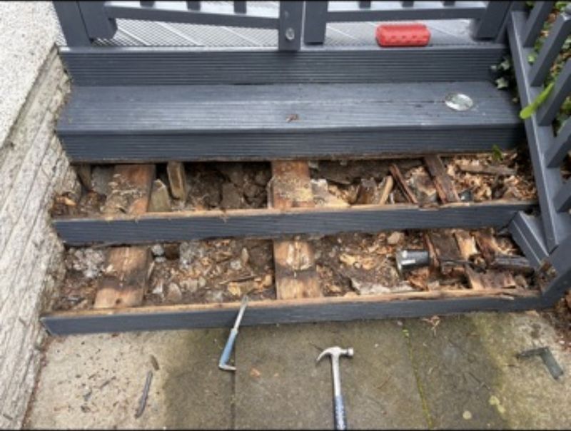 Deck steps with the boards lifted, exposing the timber bearers underneath