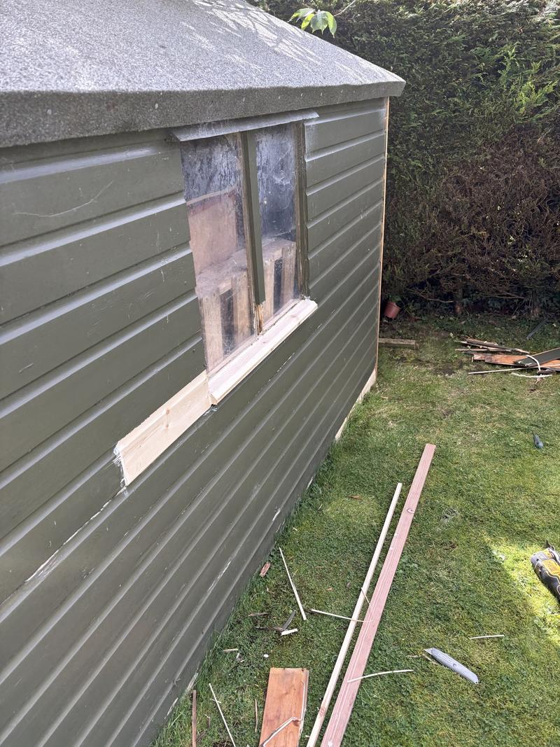 New timber cladding let into a shed wall beneath the window, with a new corner trim fitted